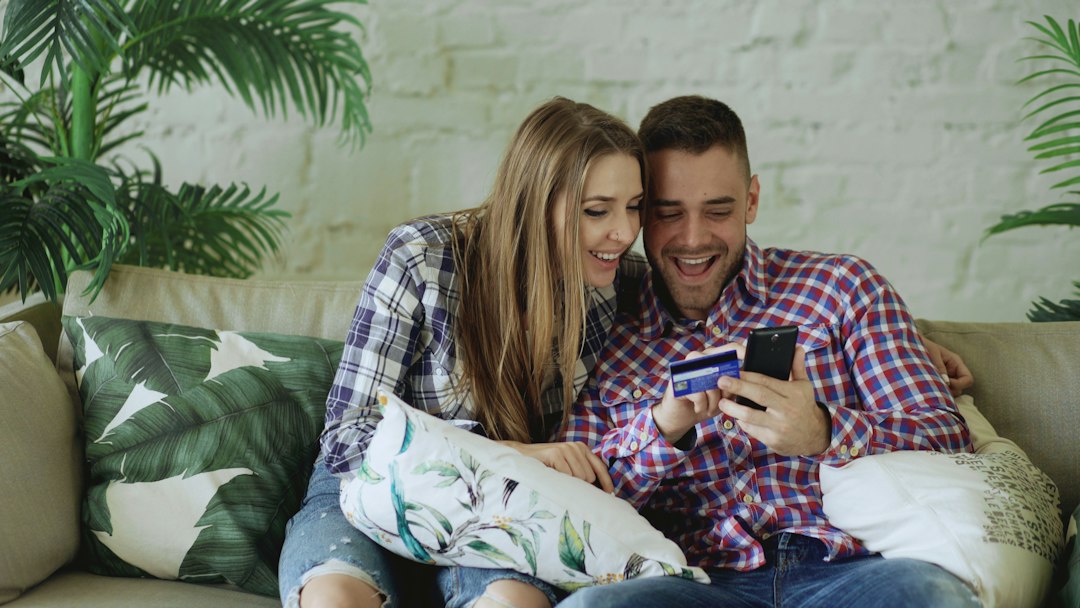Couple happily shopping online with credit card