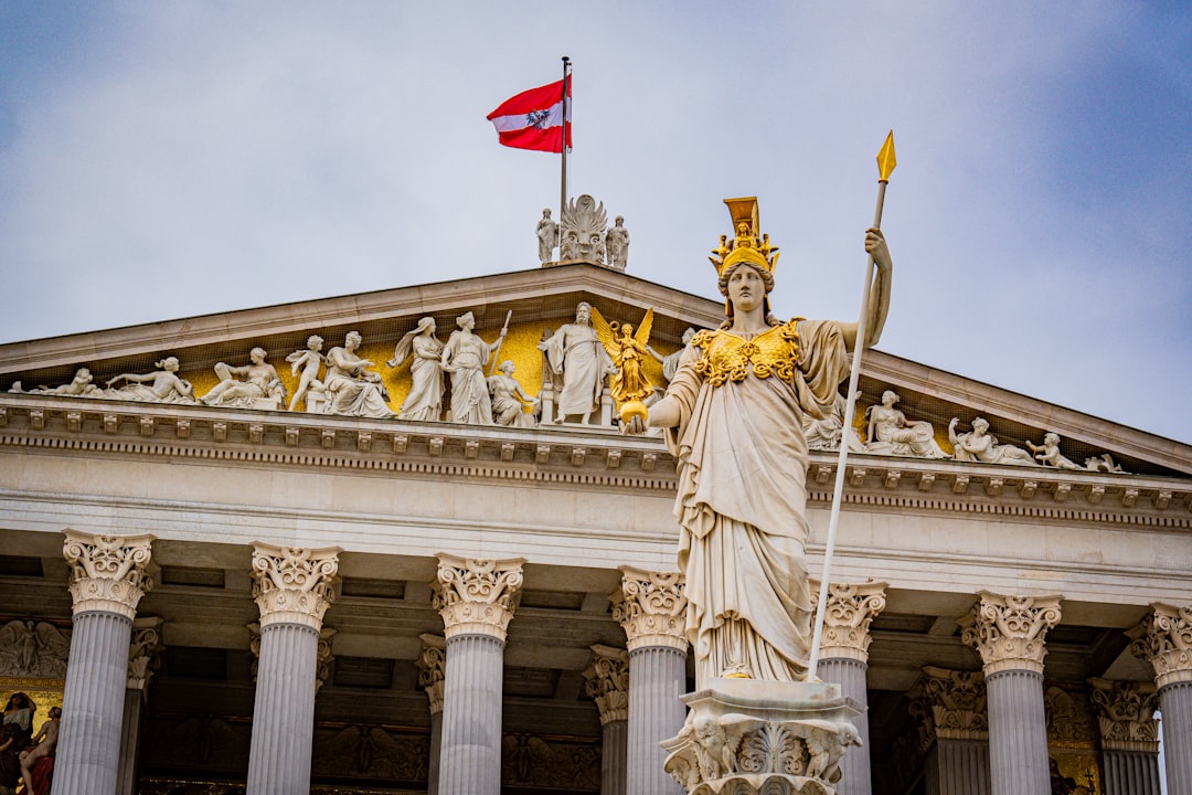 A statue of a woman holding a flag in front of a building