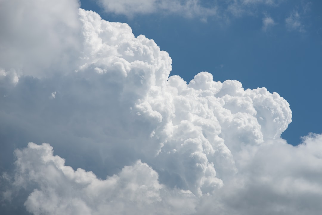 Large white fluffy clouds against a blue sky