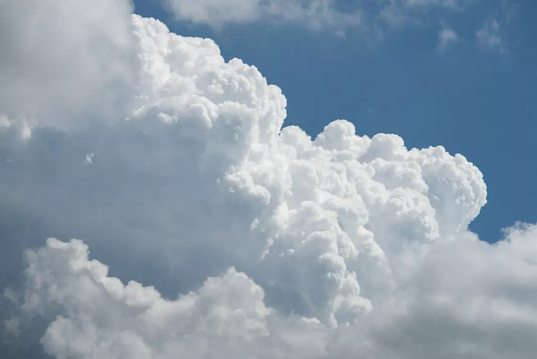 Large white fluffy clouds against a blue sky