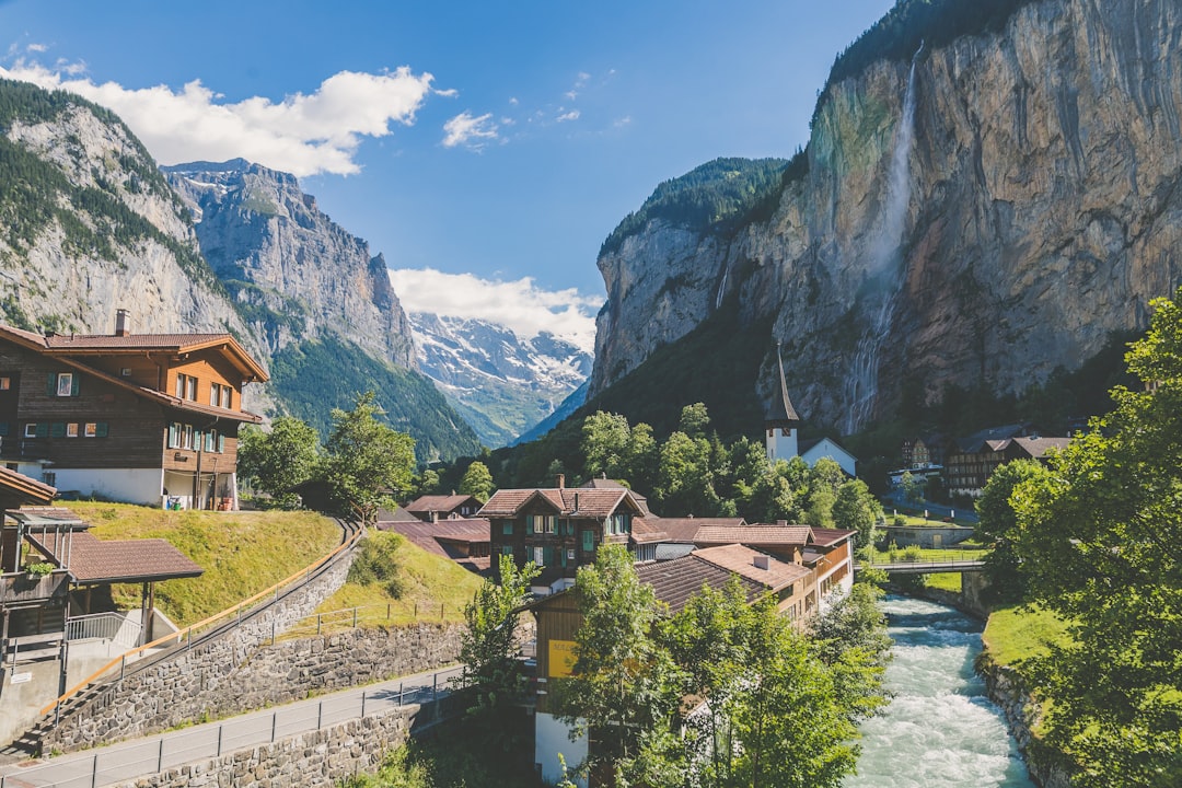 Wooden houses in the valley of Lauterbrunnen, Switzerland, with a waterfall and mountains